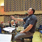 Ian rehearsing the orchestra and choir